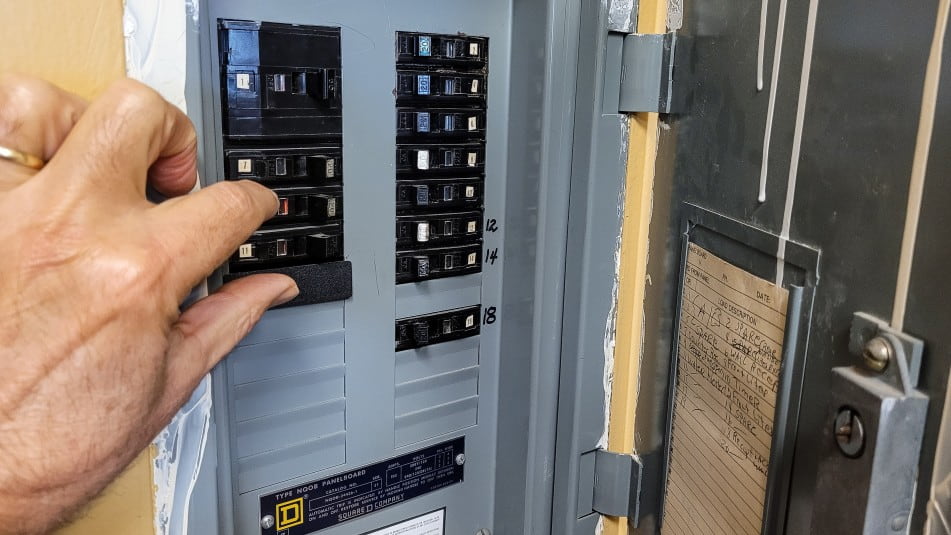 man adjusting breaker