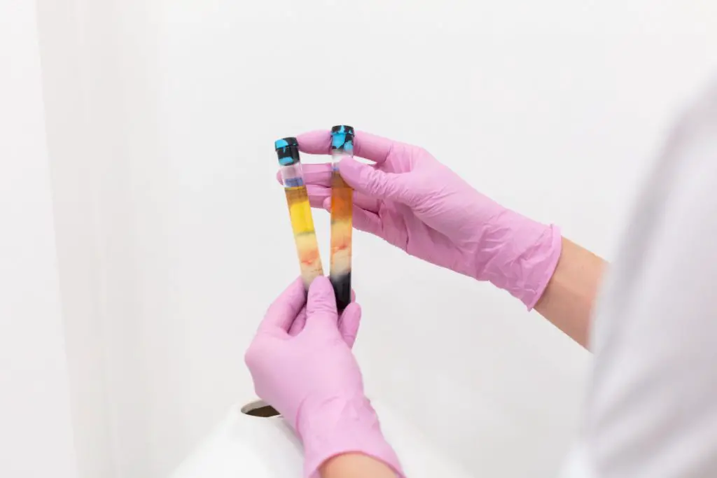 scientists holding a couple of tubes